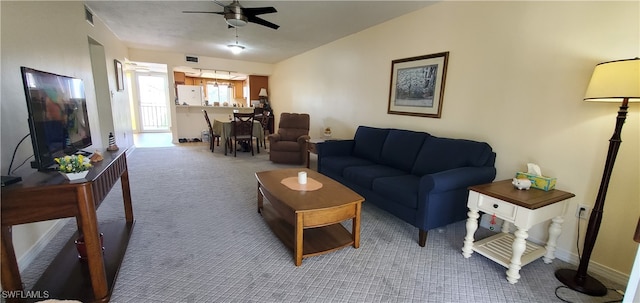 carpeted living room with ceiling fan