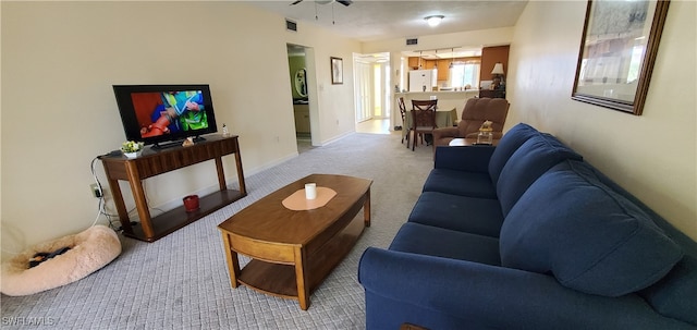 carpeted living room featuring ceiling fan