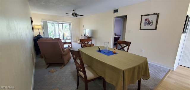 dining room with ceiling fan and light hardwood / wood-style flooring