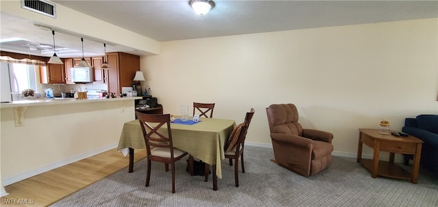 dining area with light wood-type flooring