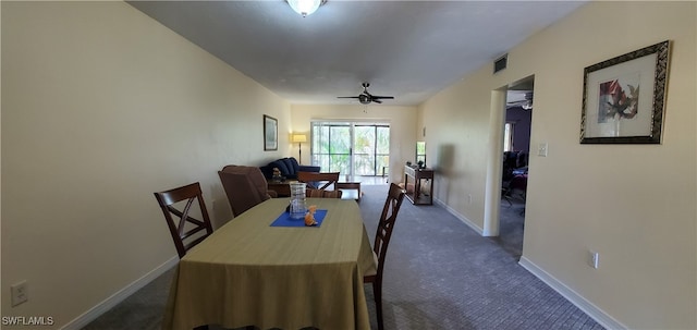 carpeted dining space with ceiling fan