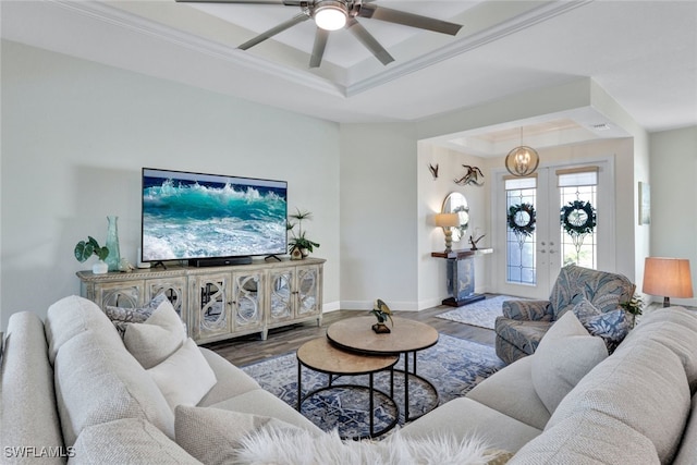 living room with baseboards, a tray ceiling, wood finished floors, and french doors