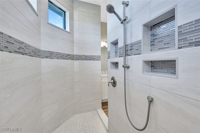 bathroom with tiled shower