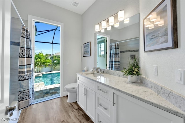 full bath with toilet, wood finished floors, vanity, visible vents, and a shower with curtain