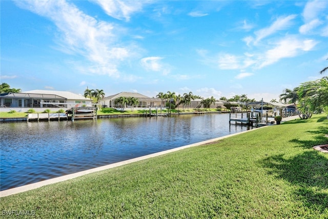 dock area with a lawn, a water view, boat lift, and a residential view