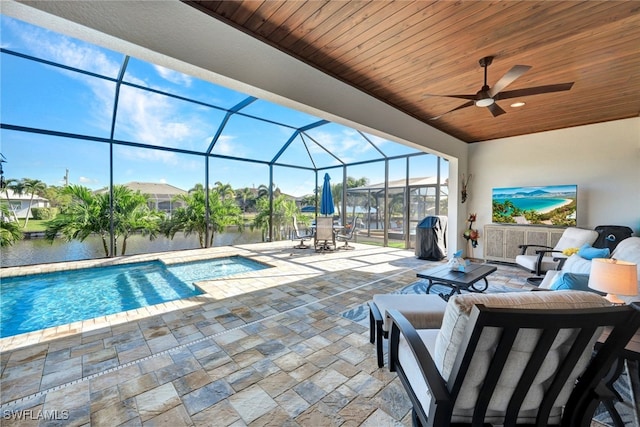 pool with ceiling fan, a patio, a lanai, a jacuzzi, and an outdoor living space