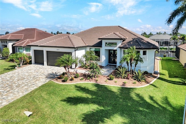 view of front of property with decorative driveway, stucco siding, an attached garage, a tiled roof, and a front lawn