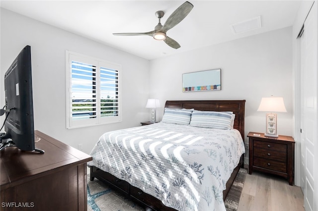 bedroom with ceiling fan and light hardwood / wood-style flooring