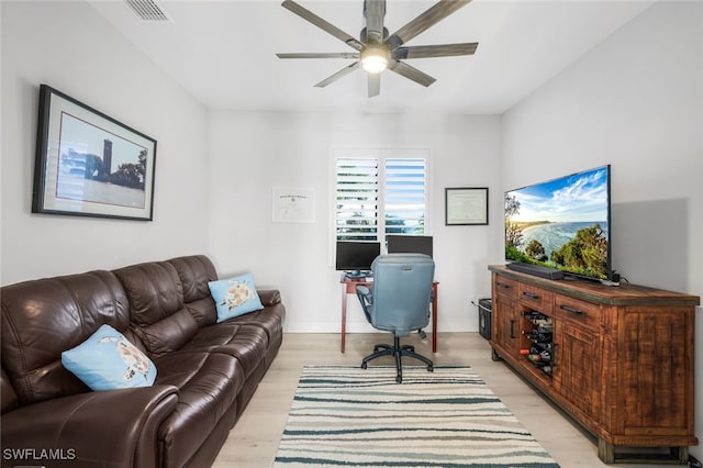 living room with light wood-type flooring and ceiling fan