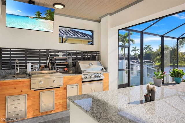 kitchen featuring ornamental molding, sink, wooden ceiling, and a healthy amount of sunlight