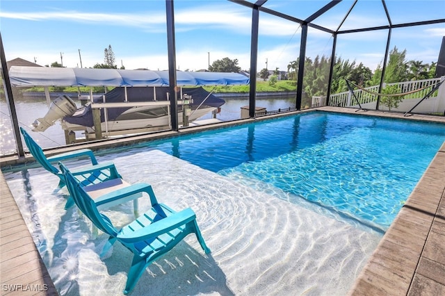 view of swimming pool with glass enclosure, a water view, and a patio