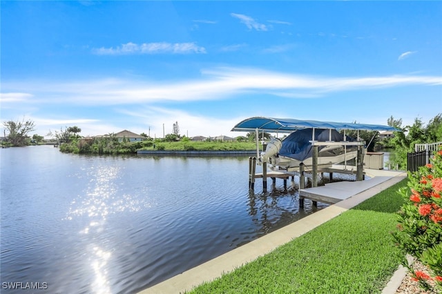 view of dock with a water view and a yard