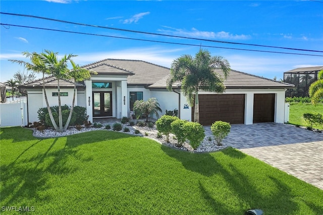 view of front of home featuring a front yard and a garage