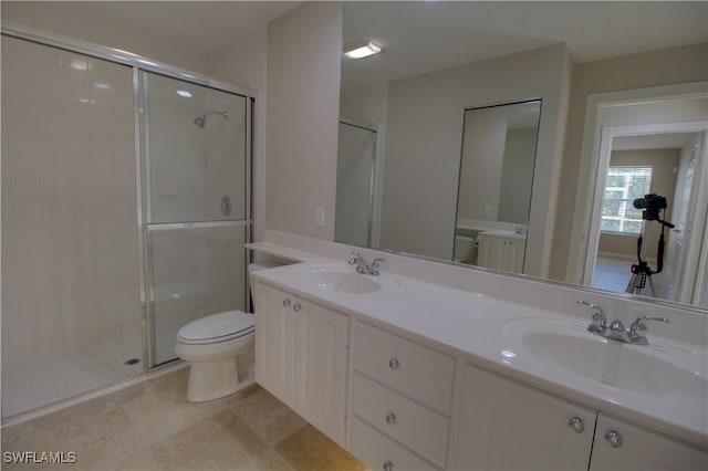 full bath with a stall shower, a sink, and toilet