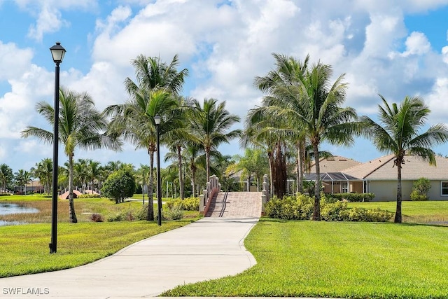 view of home's community featuring a water view and a yard