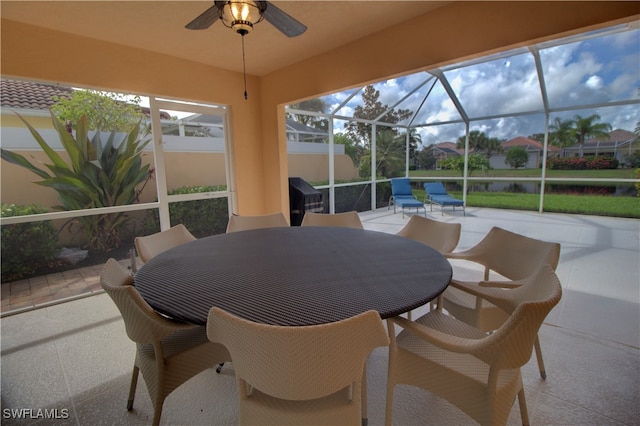 view of patio featuring glass enclosure and ceiling fan