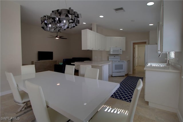 dining area with ceiling fan with notable chandelier, baseboards, visible vents, and recessed lighting