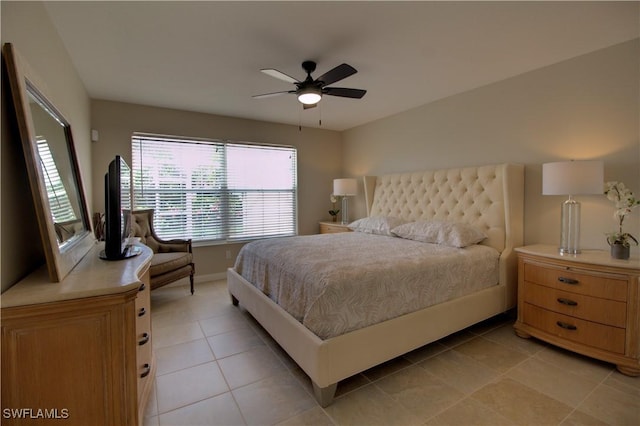 bedroom with baseboards, a ceiling fan, and light tile patterned flooring