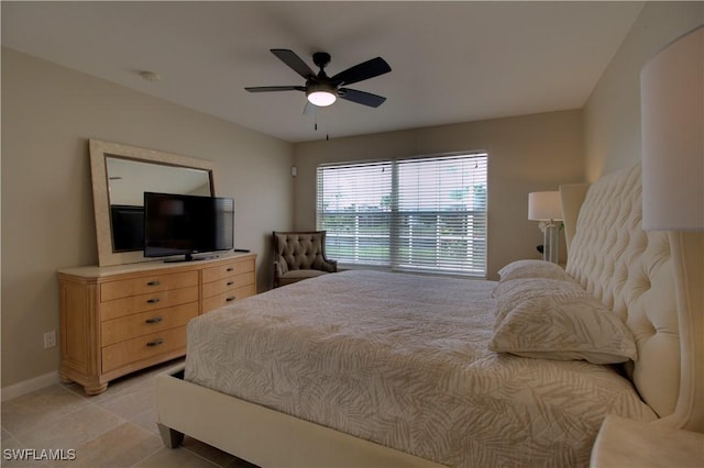 bedroom featuring light tile patterned floors, ceiling fan, and baseboards