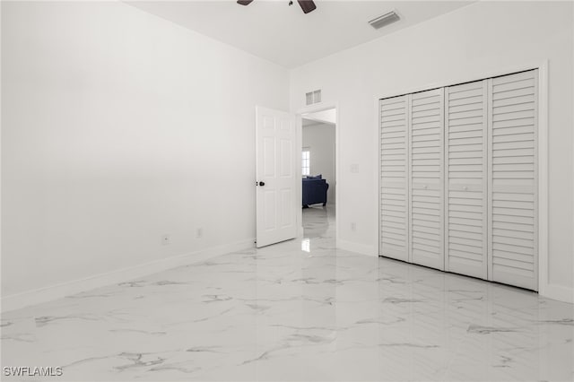 unfurnished bedroom featuring a closet and ceiling fan