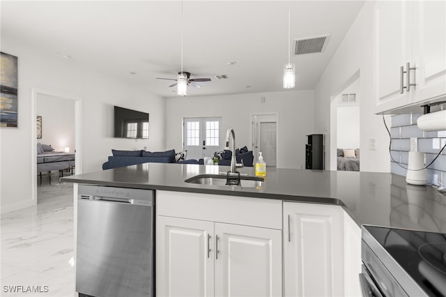 kitchen featuring hanging light fixtures, sink, white cabinets, and stainless steel dishwasher