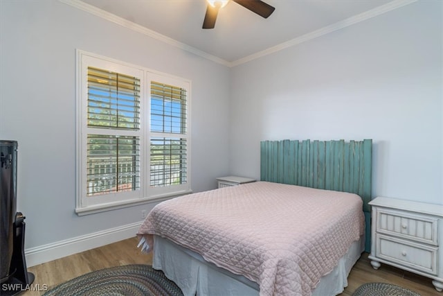 bedroom featuring ceiling fan, hardwood / wood-style flooring, and crown molding