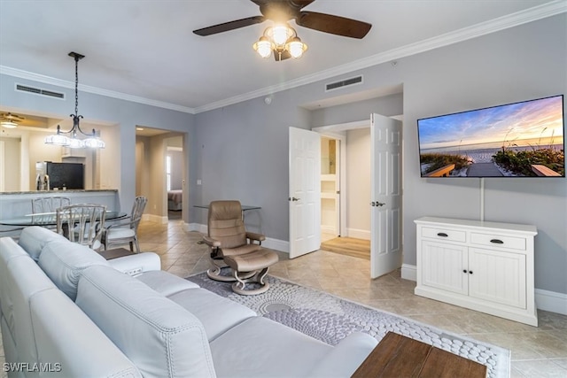 living room featuring ornamental molding, ceiling fan with notable chandelier, and light tile patterned floors