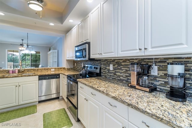 kitchen featuring ceiling fan, backsplash, white cabinets, appliances with stainless steel finishes, and light tile patterned floors