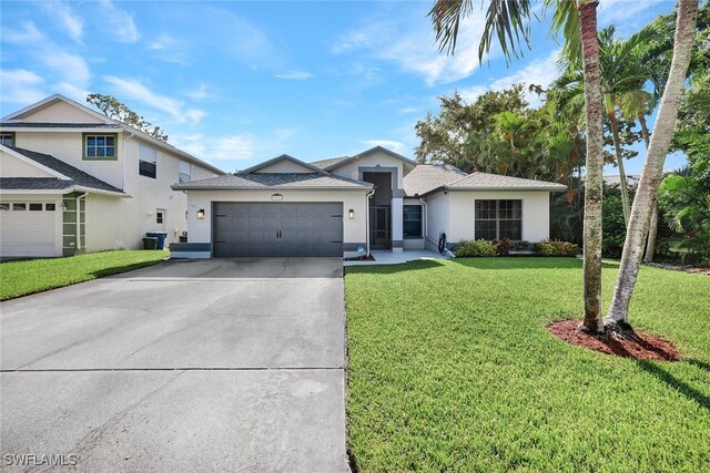 view of front of house featuring a front yard and a garage