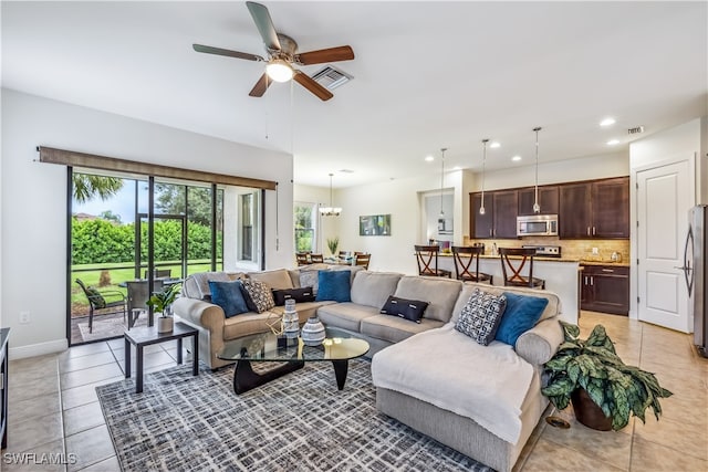 tiled living room featuring ceiling fan