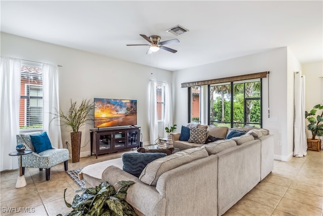 tiled living room featuring ceiling fan