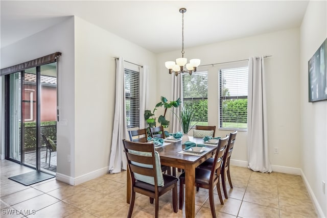 dining space with light tile patterned floors and a chandelier