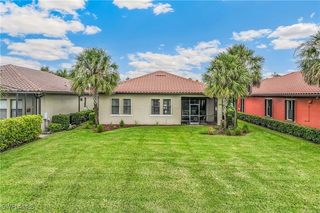 rear view of property with a lawn