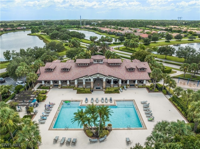 view of swimming pool with a patio and a water view