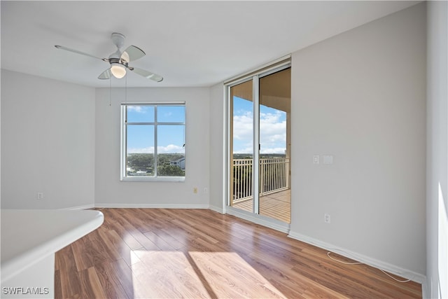 unfurnished room with hardwood / wood-style floors and ceiling fan