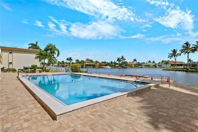 pool with a water view and a patio