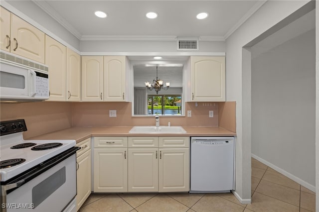 kitchen with white appliances, a sink, visible vents, light countertops, and crown molding