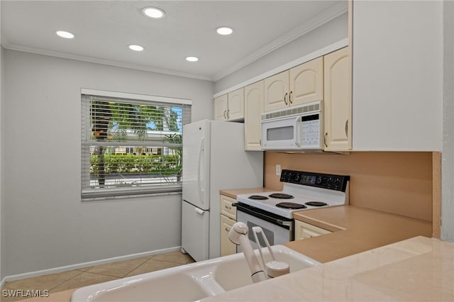 kitchen featuring crown molding, light tile patterned floors, light countertops, white appliances, and baseboards