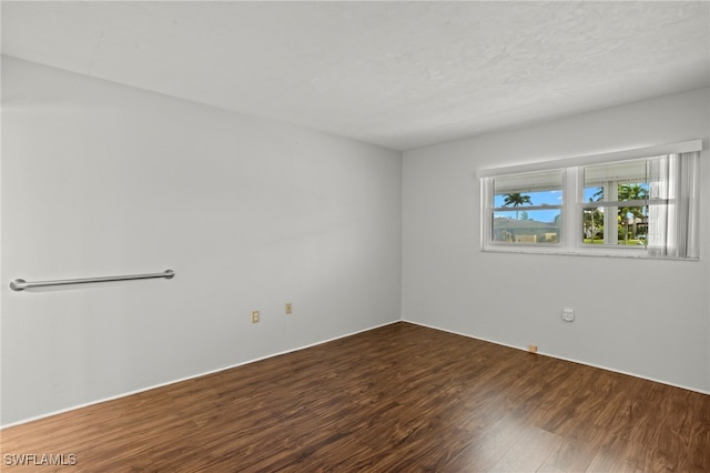 spare room featuring wood finished floors