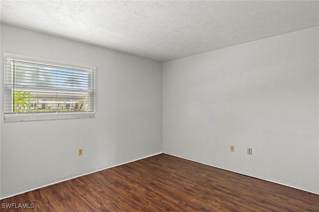 spare room with wood finished floors