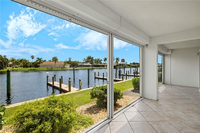 unfurnished sunroom with a water view