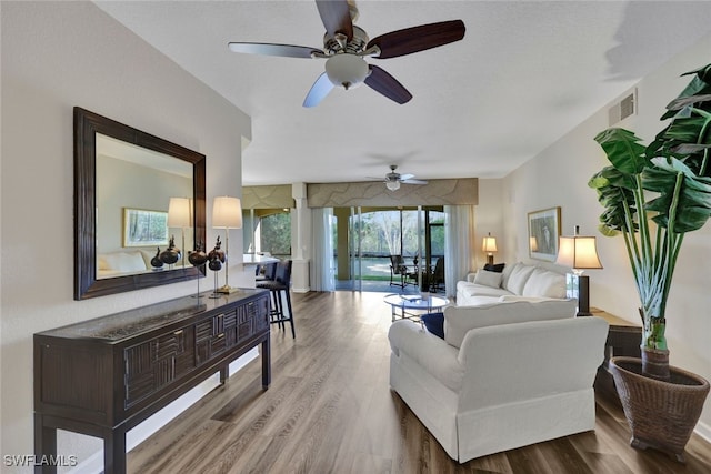 living room featuring visible vents and wood finished floors