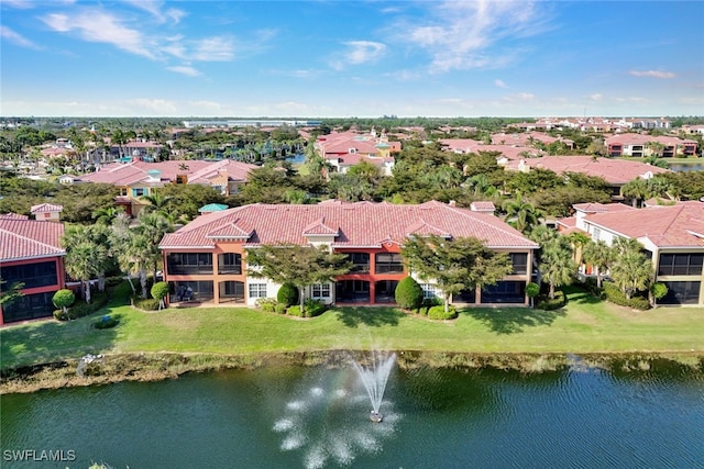 drone / aerial view with a water view and a residential view