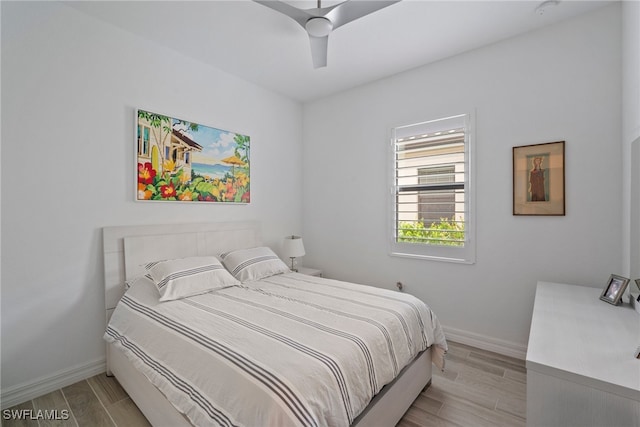 bedroom with ceiling fan and light wood-type flooring