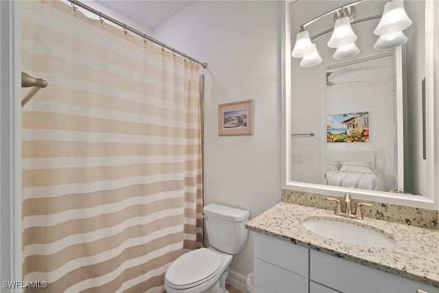 bathroom with toilet and vanity