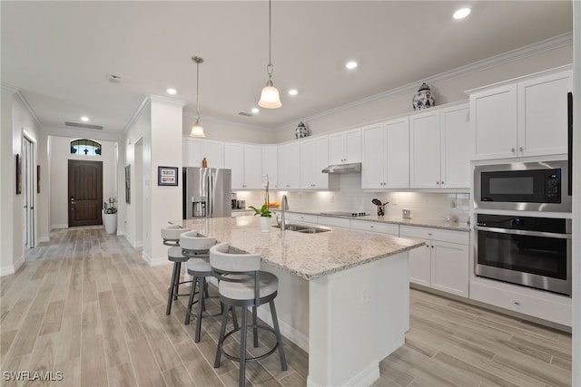 kitchen featuring decorative backsplash, light hardwood / wood-style floors, sink, crown molding, and stainless steel appliances