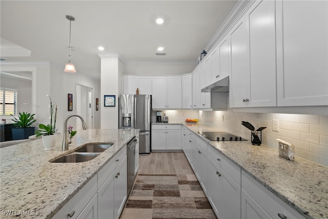 kitchen with decorative backsplash, light hardwood / wood-style flooring, sink, crown molding, and stainless steel appliances