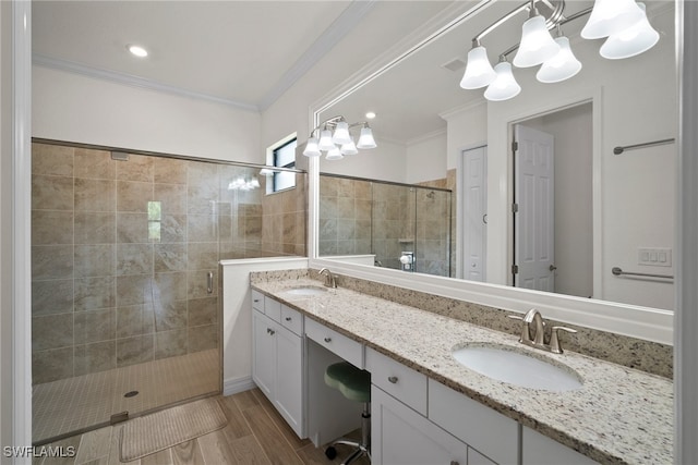 bathroom with a shower with shower door, crown molding, and dual bowl vanity