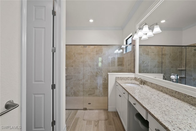 bathroom with an enclosed shower, crown molding, and vanity