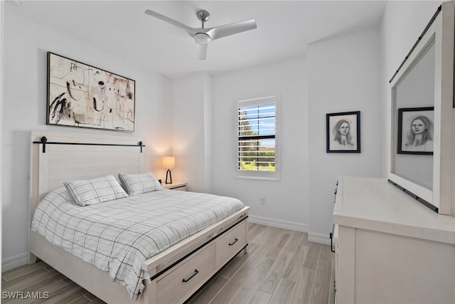 bedroom with light hardwood / wood-style flooring and ceiling fan